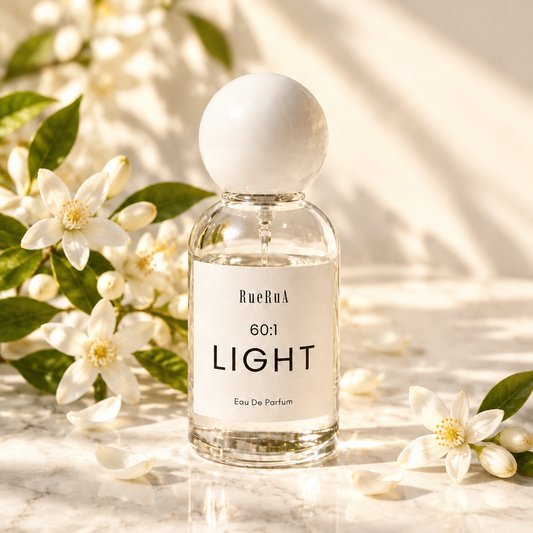 A clear glass bottle of RueBul 60:1 LIGHT Eau De Parfum with a white spherical cap, set against a light gray background.